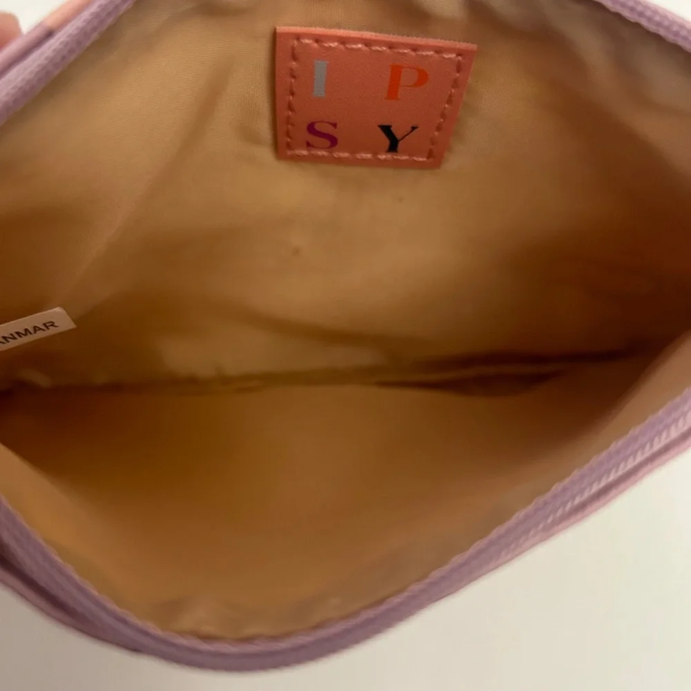 Ipsy Glam Bag featuring a lavender floral print & signature wooden zipper pull